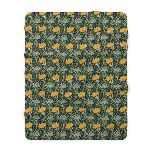 A plush fleece blanket with a yellow chrysanthemum pattern on a green background, laid flat.