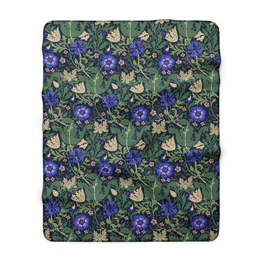 Floral patterned fabric with blue flowers and green leaves on a white background
