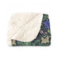 Floral-patterned blanket with white sherpa lining on a white background