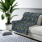 Floral-patterned sofa cover on a white sofa with a plant and rug in the background