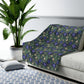 Floral-patterned sofa cover on a white sofa with a plant and rug in the background