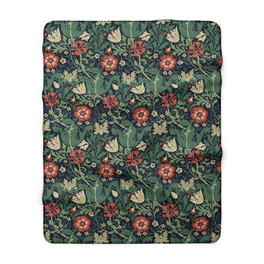 Floral patterned blanket with red flowers and green leaves on a white background