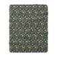 Floral patterned blanket with red flowers on a green background