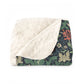Floral patterned blanket with white sherpa lining on a white background