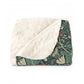 Blanket with floral pattern on one side and white fleece on the other, folded neatly.
