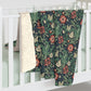 Floral patterned blanket draped over a white crib