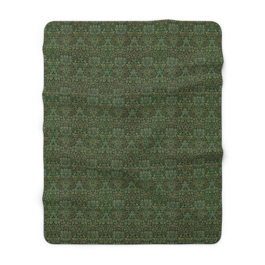 A plush fleece blanket with a floral pattern in green tones, laid flat.