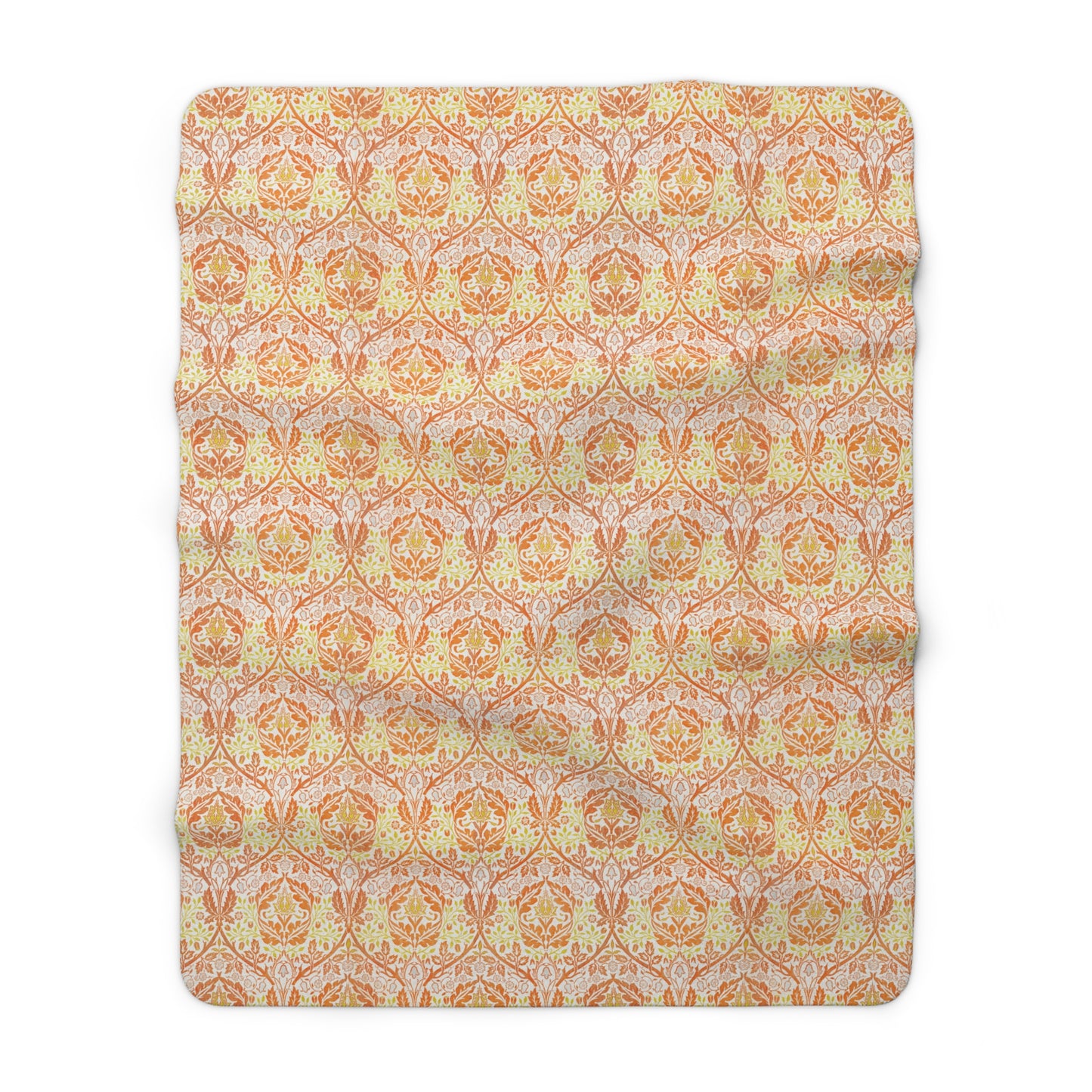 A plush fleece blanket with a geometric pattern in orange and cream colours, laid out flat.