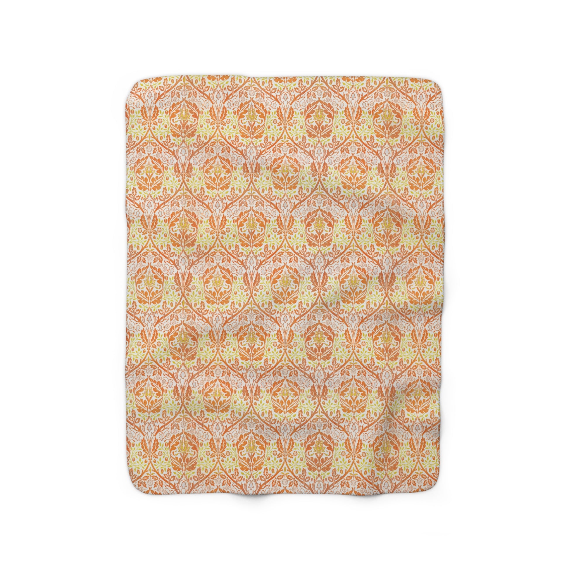 A plush fleece blanket with a geometric pattern in orange and cream colours, laid out flat.
