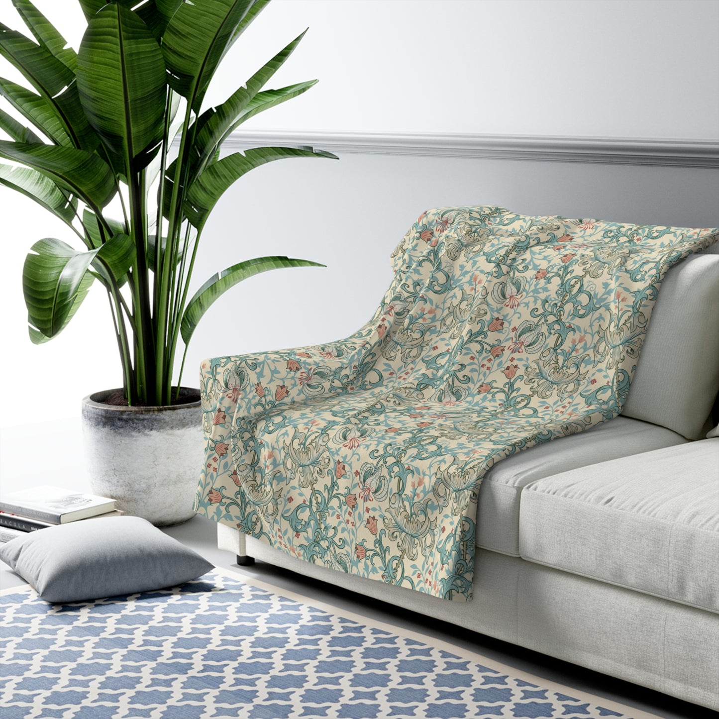 Sofa with a decorative blanket featuring American flag patterns in a living room setting.