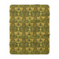 Green and gold patterned fabric on a white background