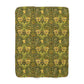 Green patterned blanket with a floral design on a white background