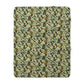 A green Sherpa fleece blanket with a floral pattern inspired by William Morris, displayed flat.
