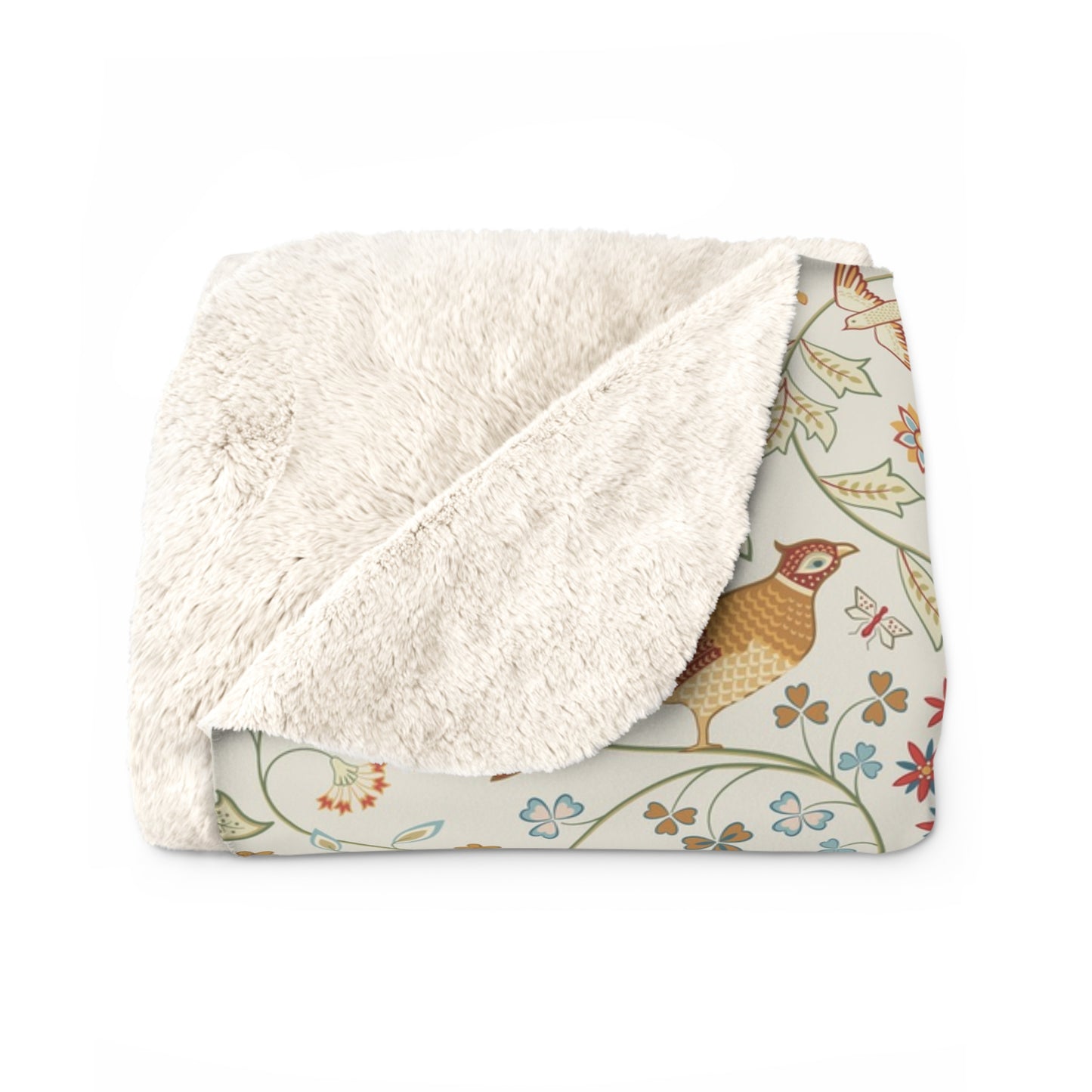Floral-patterned blanket with white sherpa lining on a white background