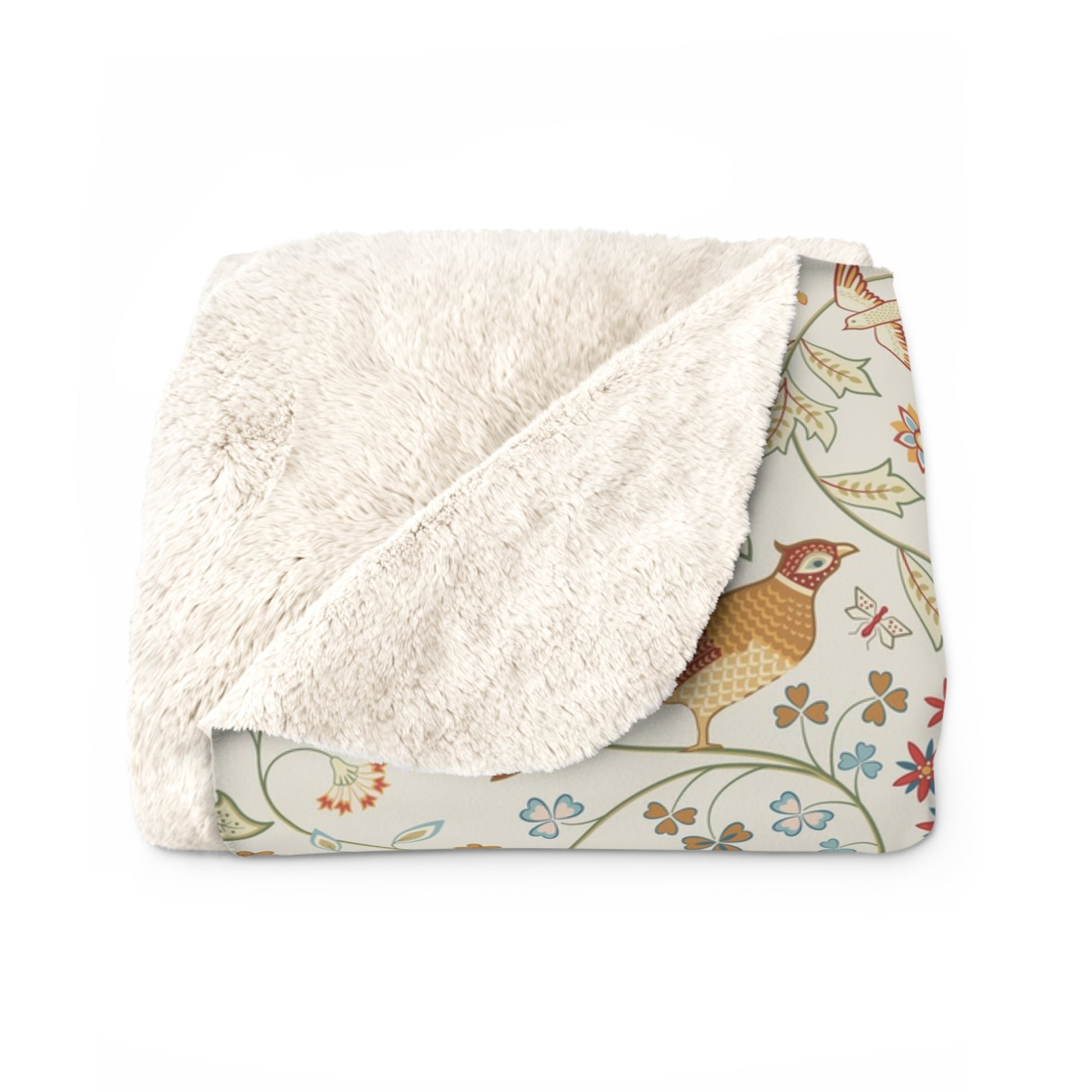 Floral-patterned blanket with white sherpa lining on a white background