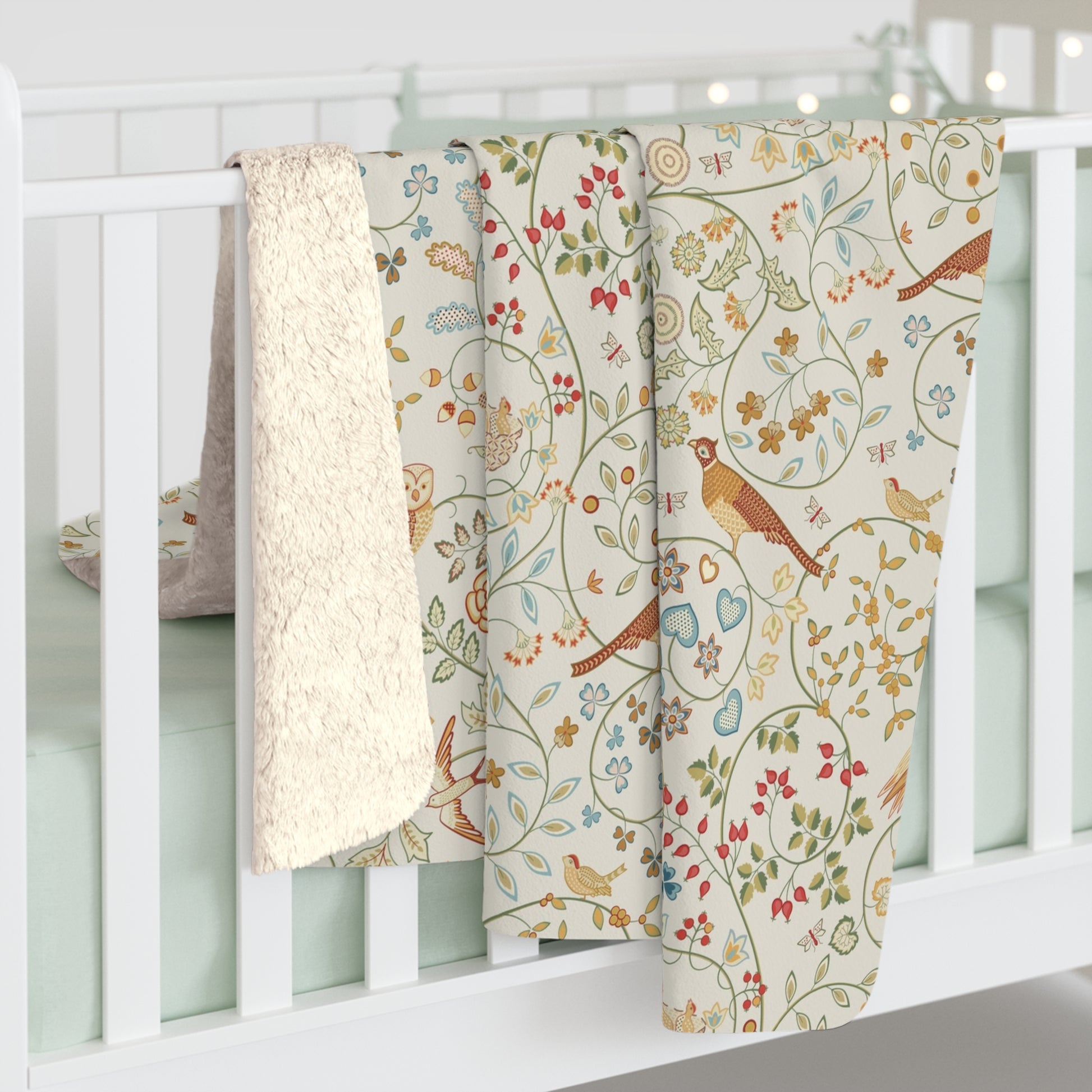 Three patterned baby blankets hanging on a white crib
