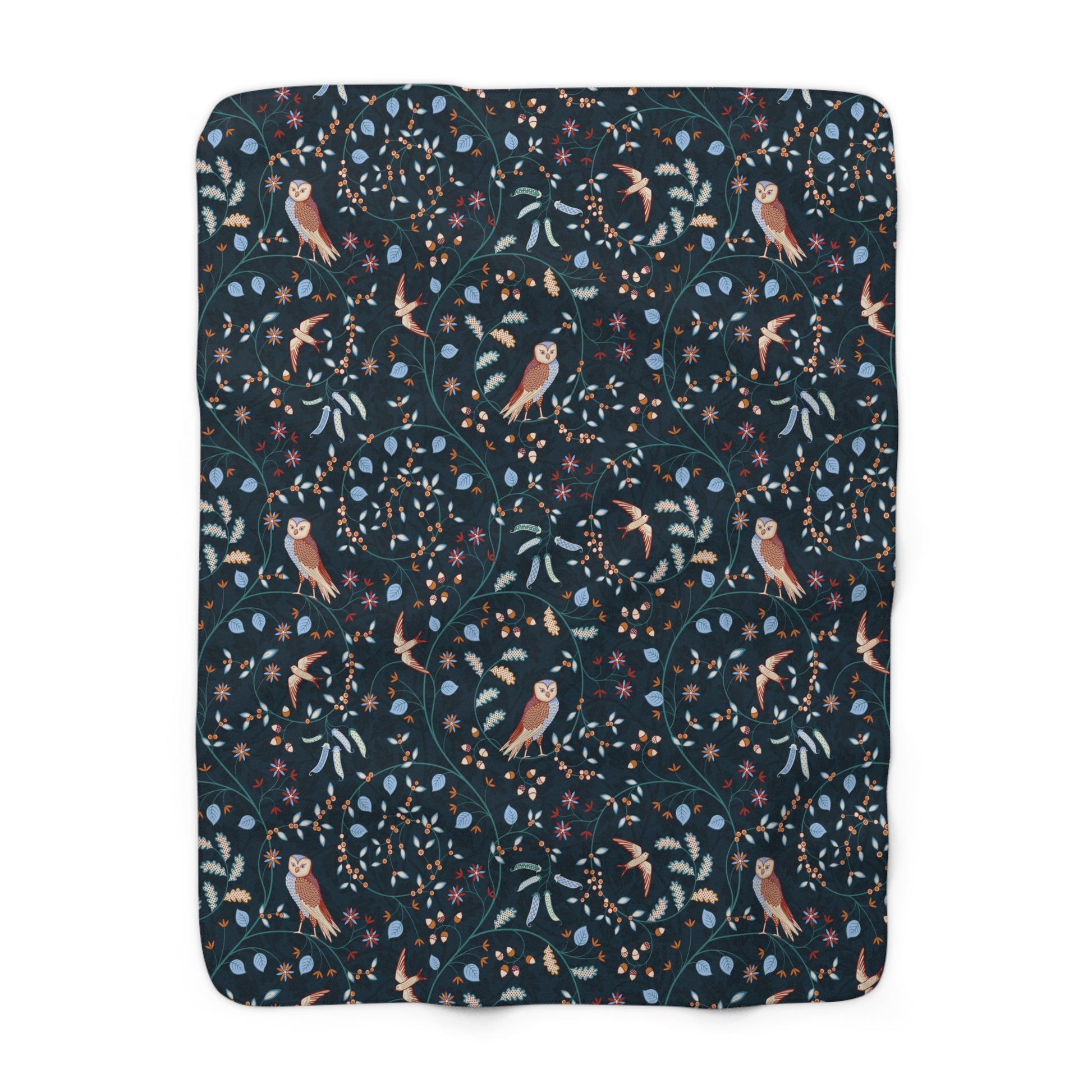 Floral and bird patterned blanket on a white background