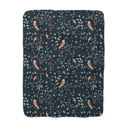 Floral and bird patterned blanket on a white background