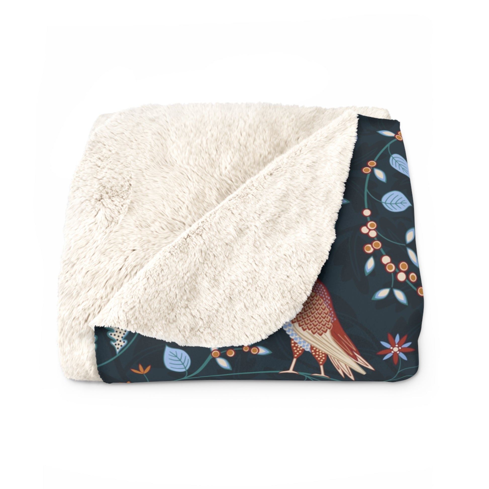 Floral-patterned blanket with white sherpa lining on a white background