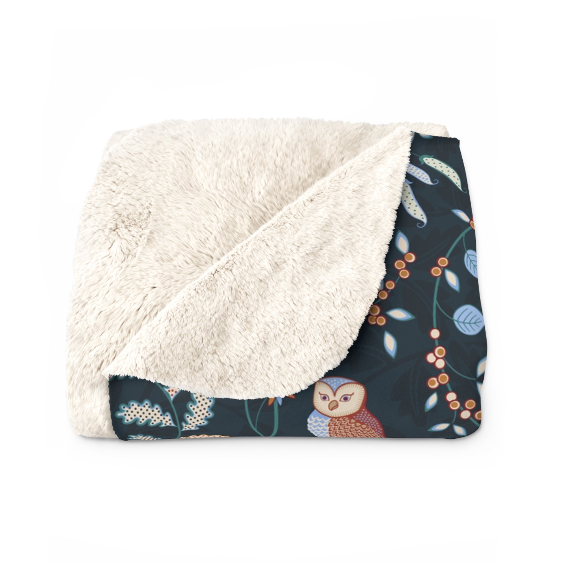 Floral-patterned blanket with white sherpa lining on a white background