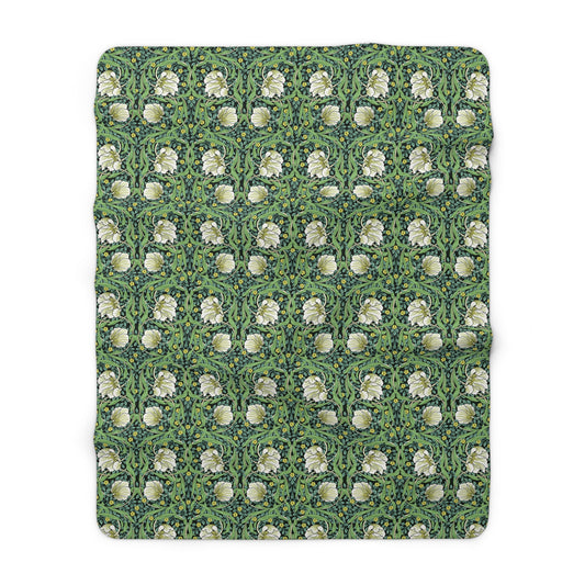 A green Sherpa fleece blanket with a floral pattern inspired by William Morris.