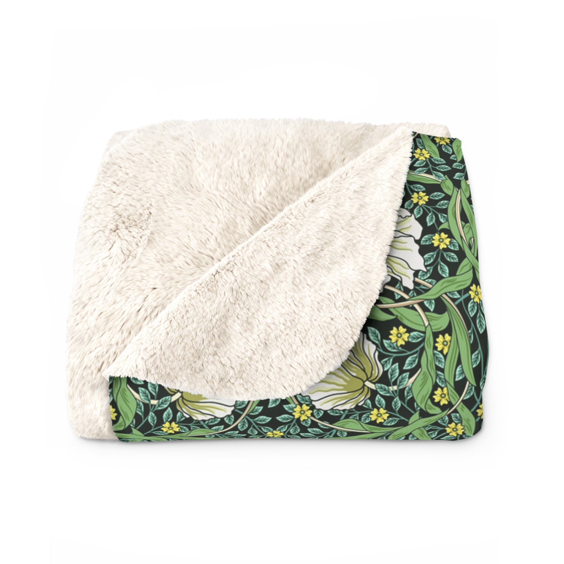 A green Sherpa fleece blanket with a floral pattern inspired by William Morris.