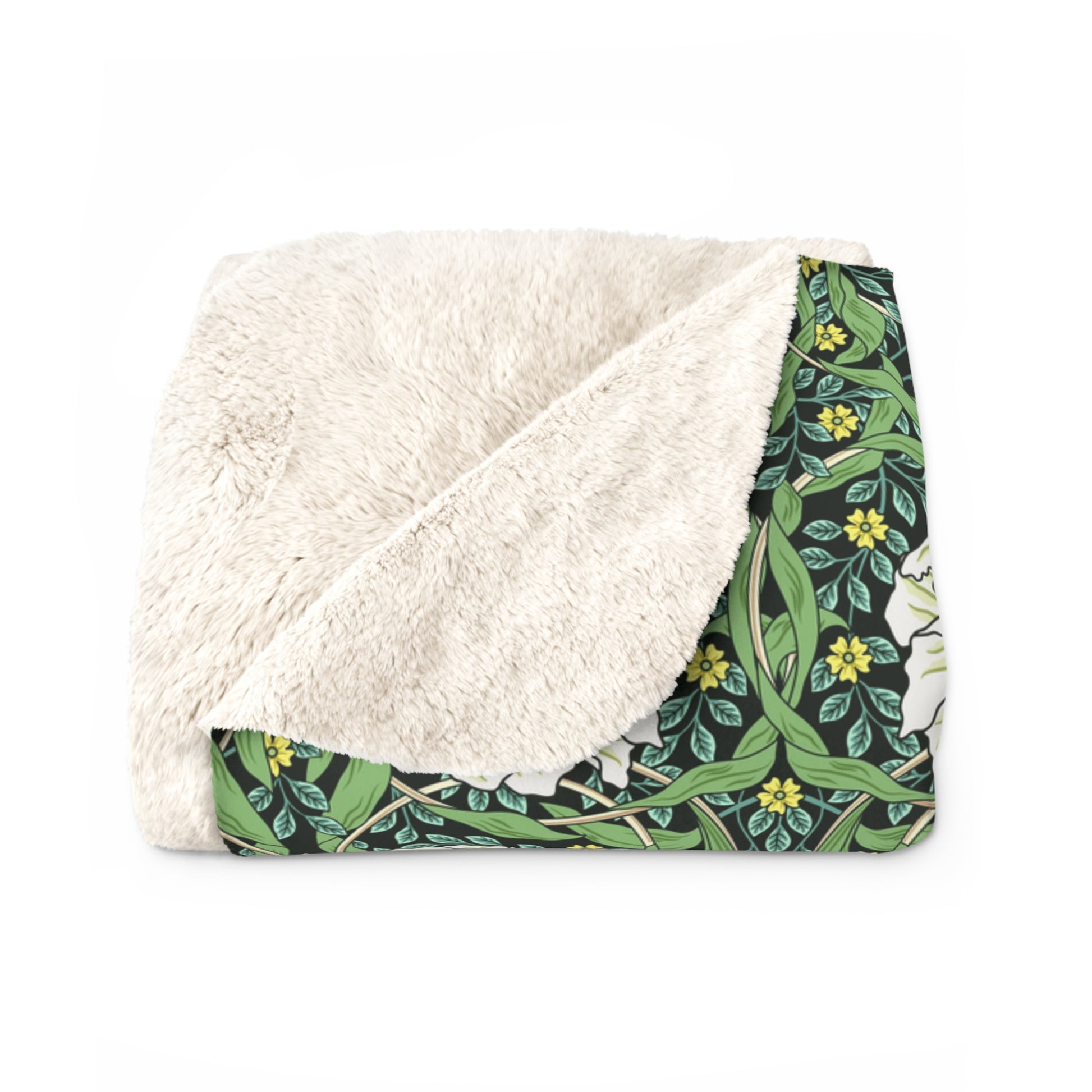 A green Sherpa fleece blanket with a floral pattern inspired by William Morris.
