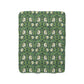 A green Sherpa fleece blanket with a floral pattern inspired by William Morris.
