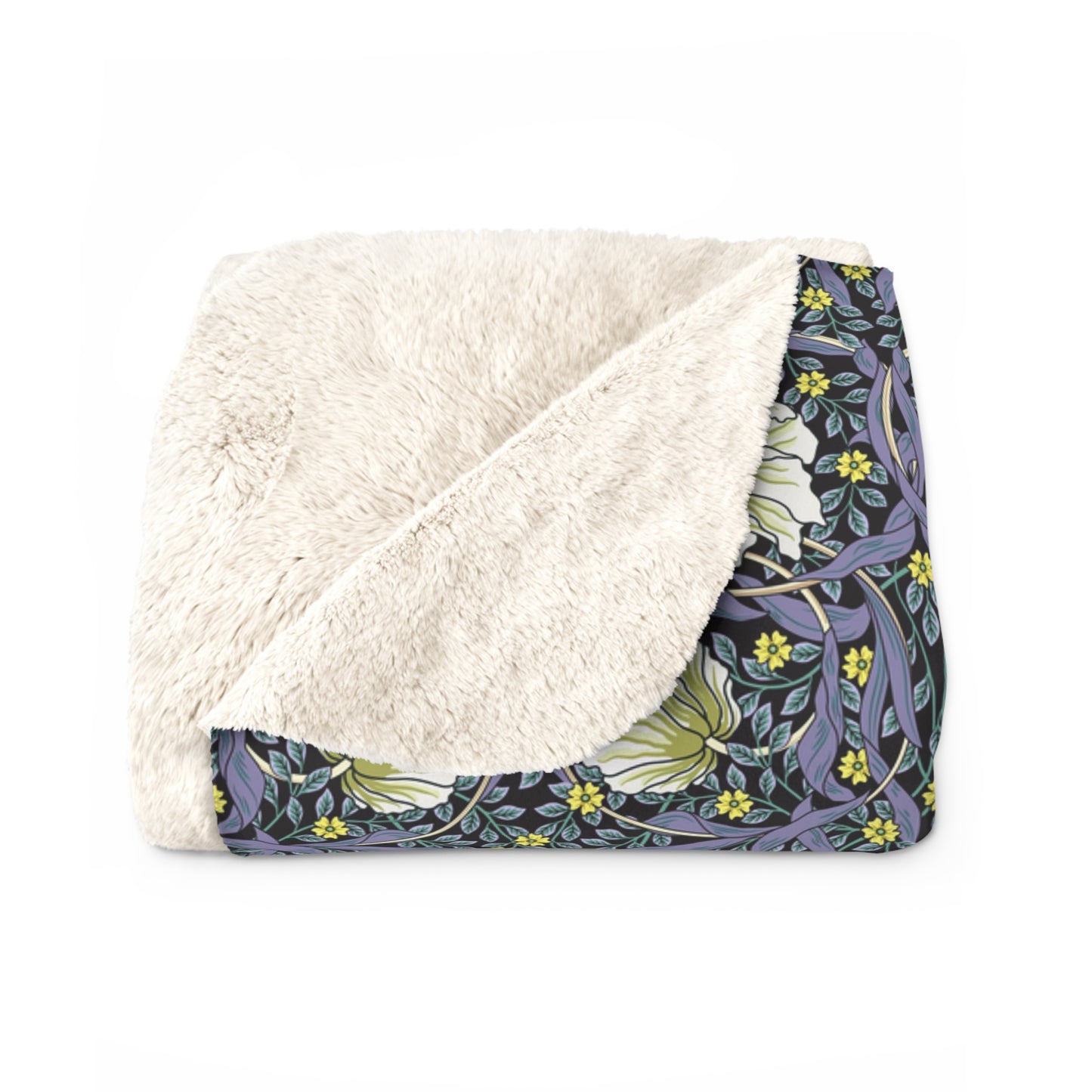 A cozy fluffy fleece blanket with a floral pattern in shades of purple and green, bound by a solid purple edge.