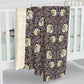 A plush fleece blanket with a floral pattern in a purple hue, inspired by William Morris, displayed on a white background.