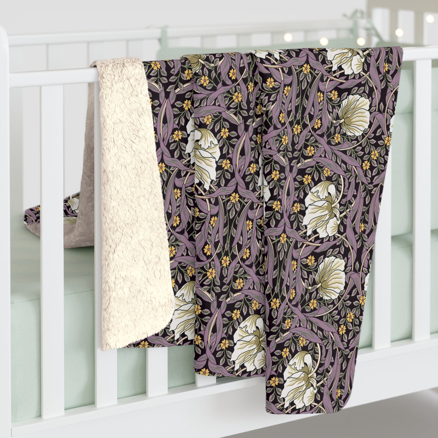 A plush fleece blanket with a floral pattern in a purple hue, inspired by William Morris, displayed on a white background.