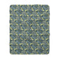 A rectangular Sherpa fleece blanket with a floral pattern in blue and yellow shades, inspired by William Morris & Co