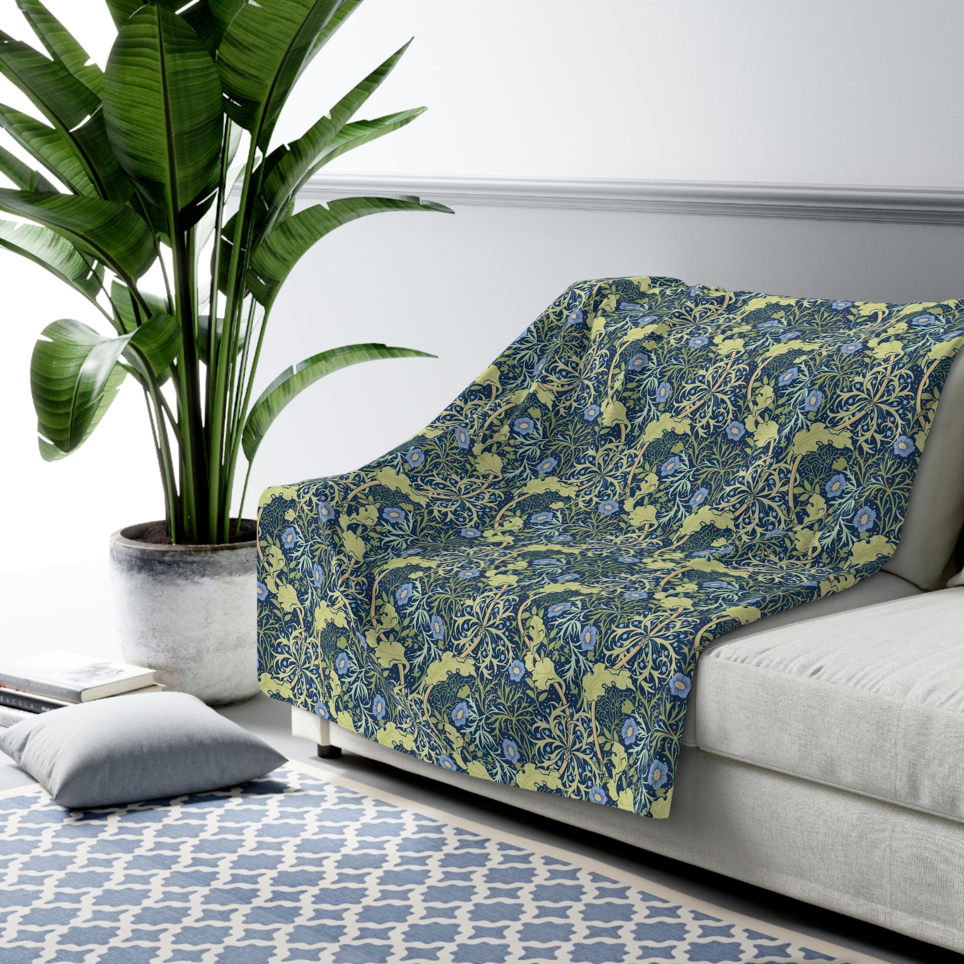 A rectangular Sherpa fleece blanket with a floral pattern in blue and yellow shades, inspired by William Morris & Co