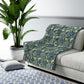A rectangular Sherpa fleece blanket with a floral pattern in blue and yellow shades, inspired by William Morris & Co