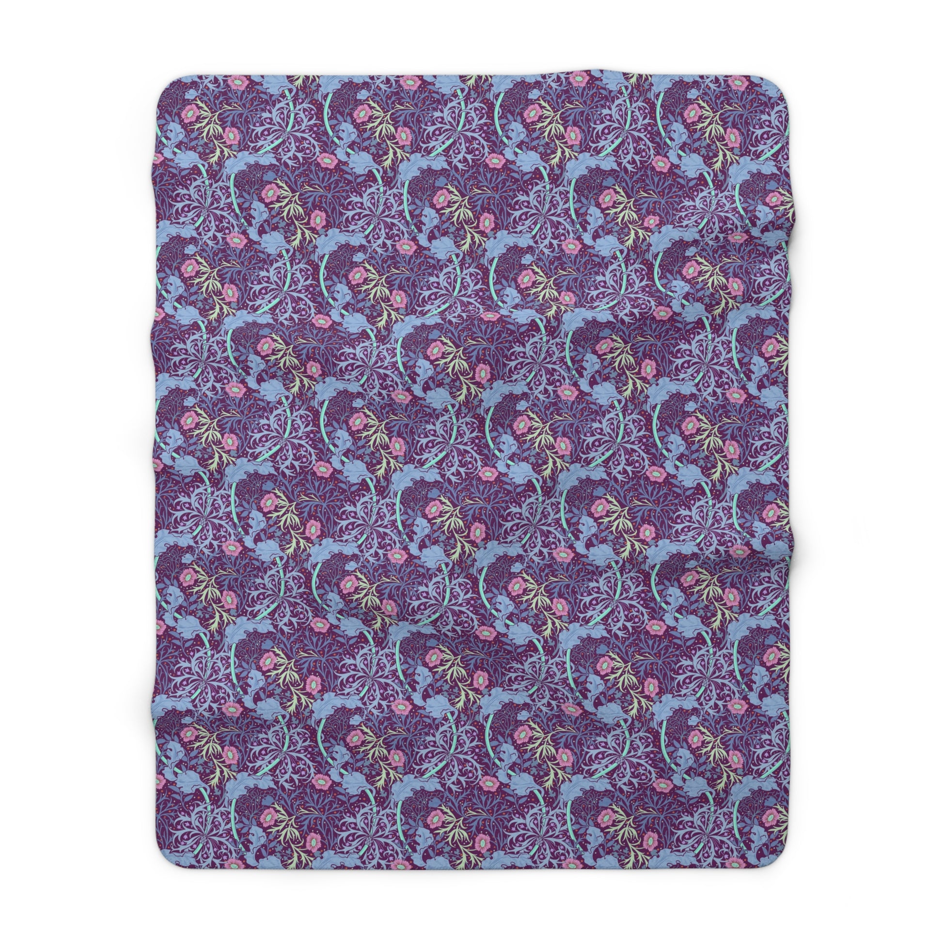 A rectangular Sherpa fleece blanket with a floral William Morris & Co pattern in pink and purple colours.