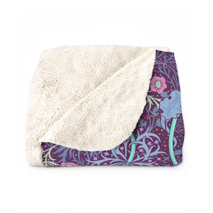 A rectangular Sherpa fleece blanket with a floral William Morris & Co pattern in pink and purple colours.