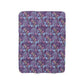 A rectangular Sherpa fleece blanket with a floral William Morris & Co pattern in pink and purple colours.