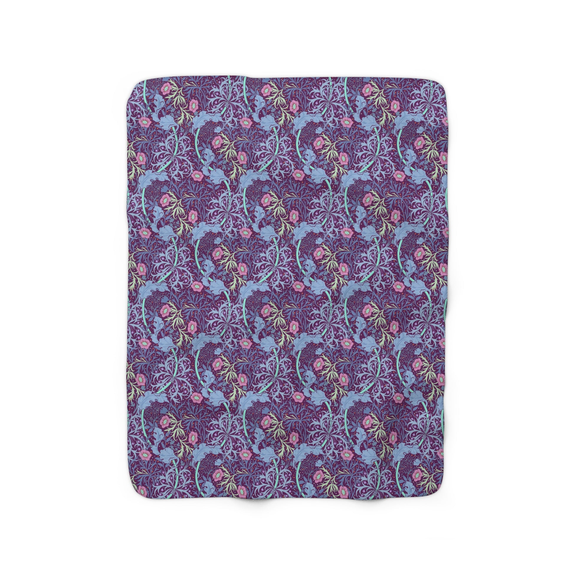 A rectangular Sherpa fleece blanket with a floral William Morris & Co pattern in pink and purple colours.