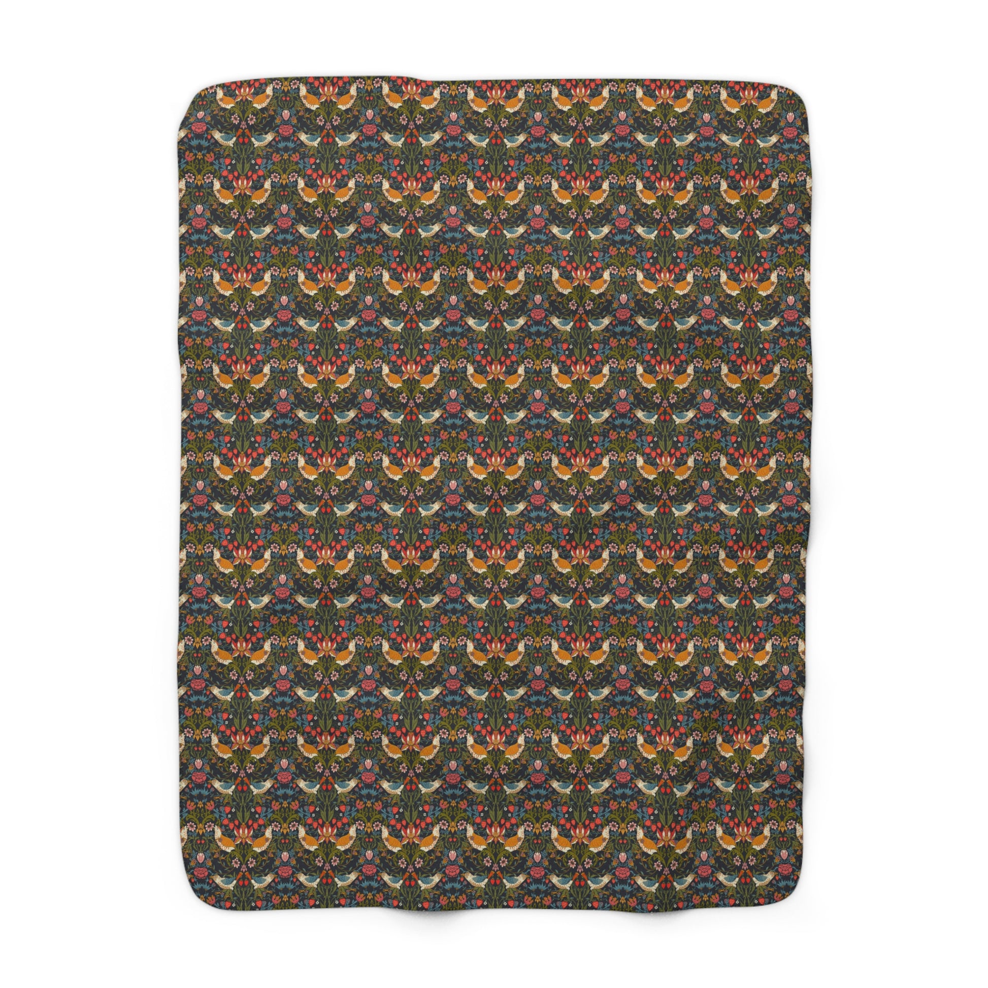 A Sherpa fleece blanket with a geometric William Morris & Co pattern featuring birds and floral-like designs on a dark background.