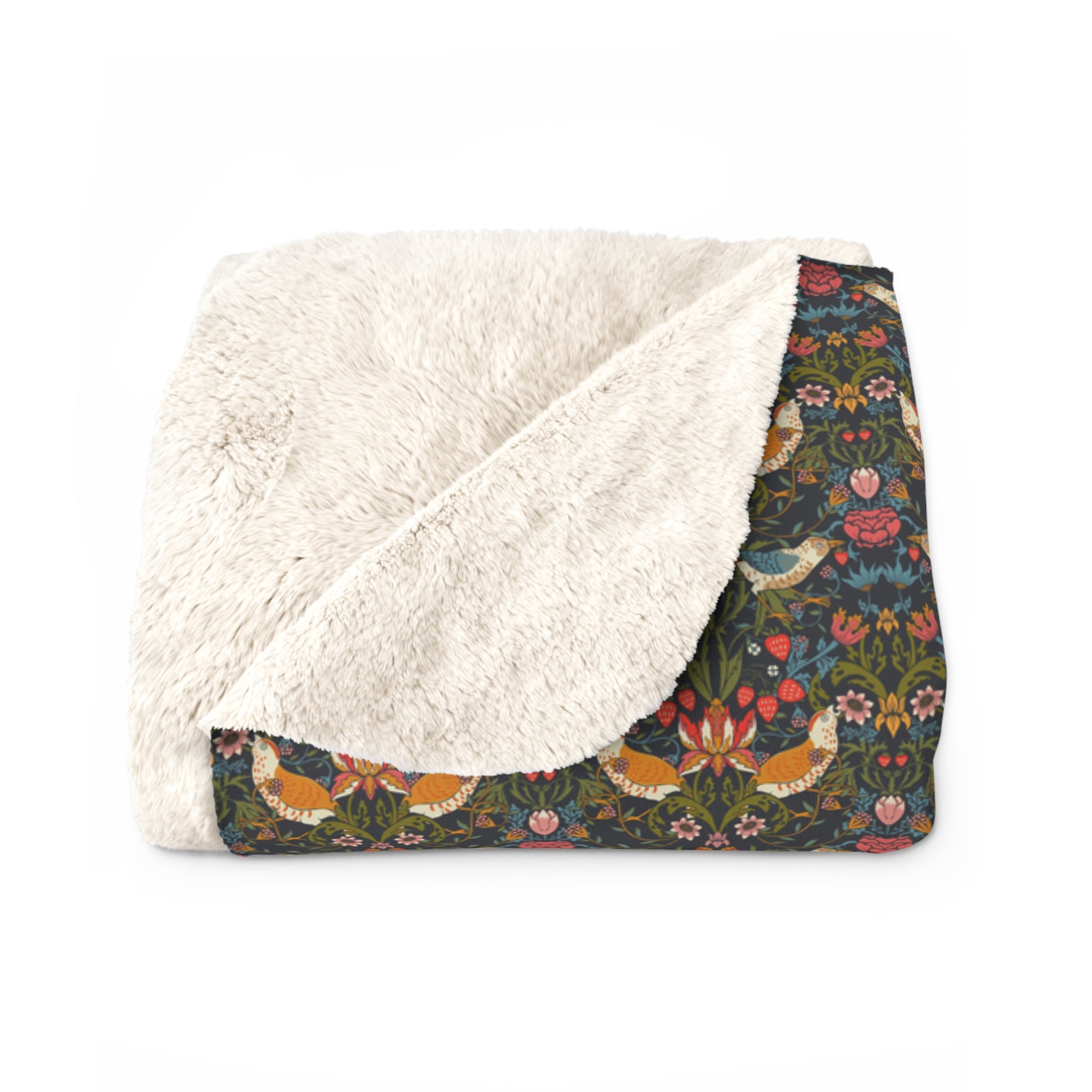 Floral patterned blanket with white sherpa lining on a white background