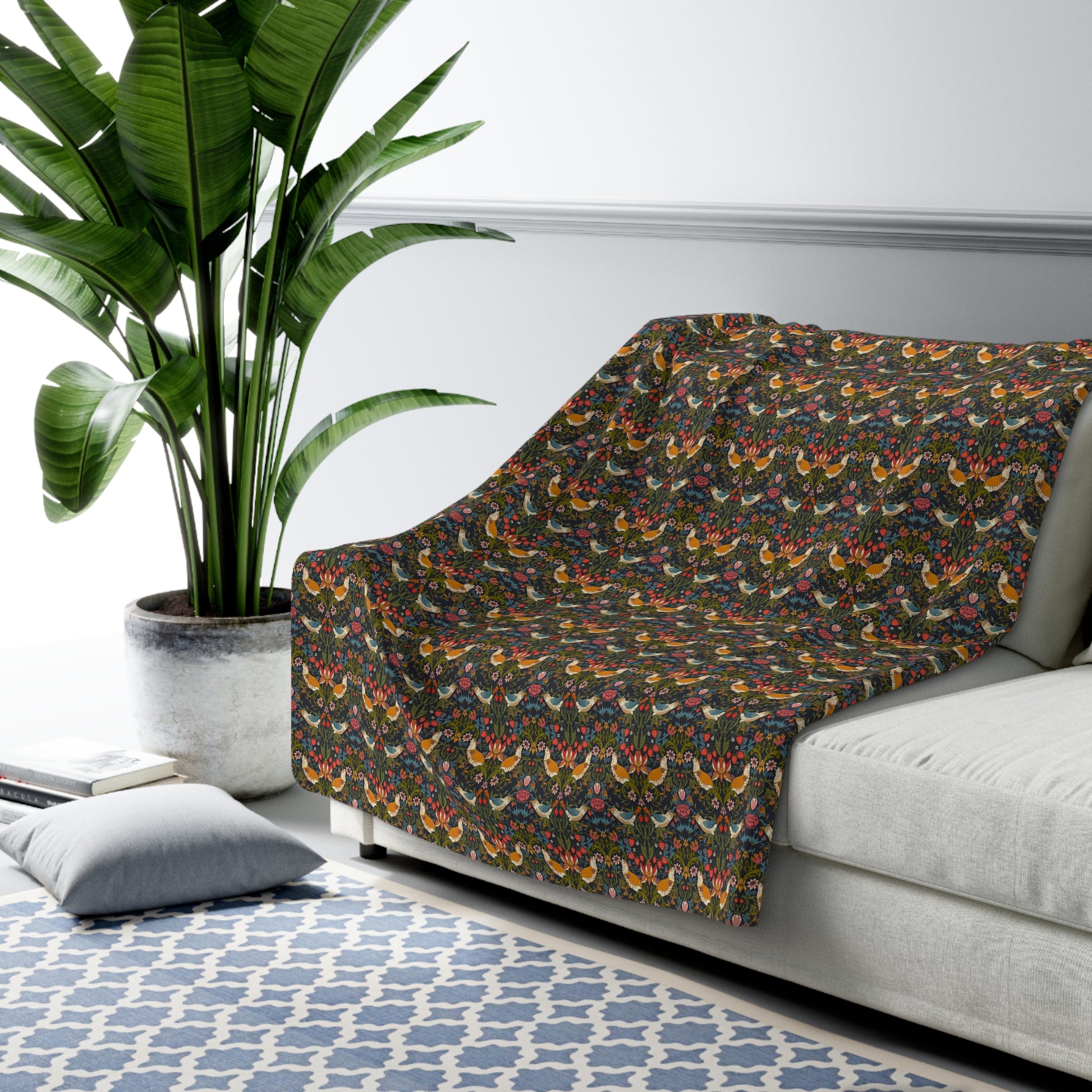 Sofa with a colorful patterned cover in a living room setting with a plant and rug.
