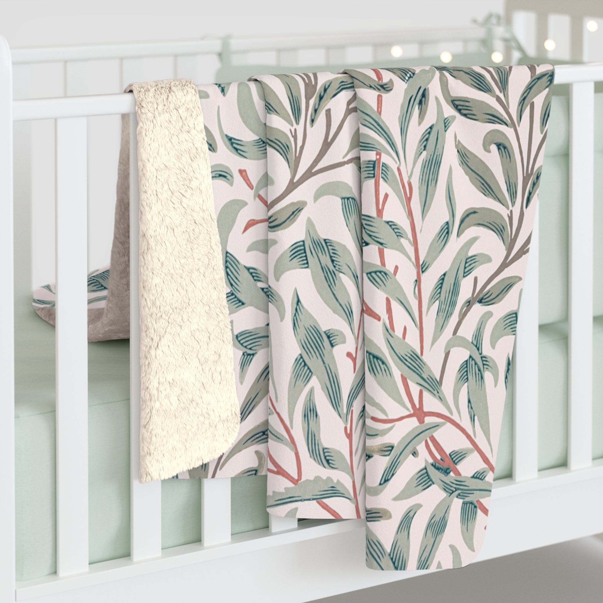 Floral-patterned blanket draped over a white crib