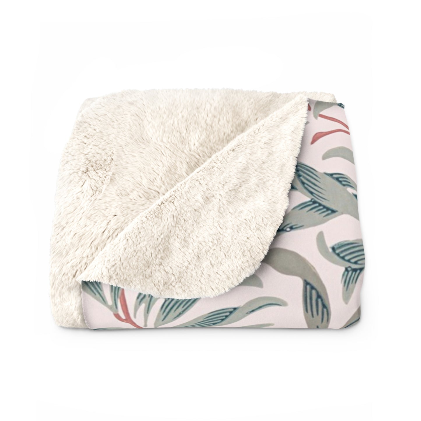 Folded blanket with white fleece interior and leaf pattern exterior on a white background