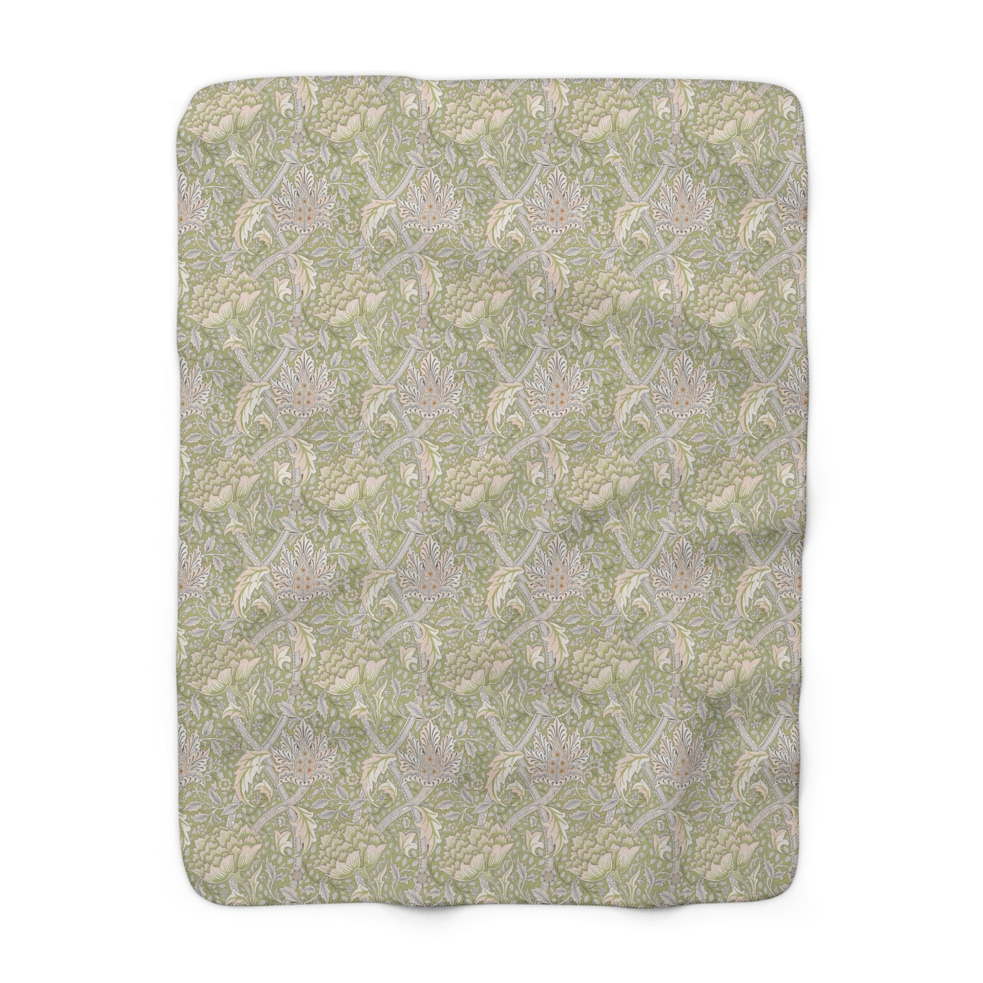 A plush fleece blanket with a floral pattern in green and white tones, inspired by William Morris.