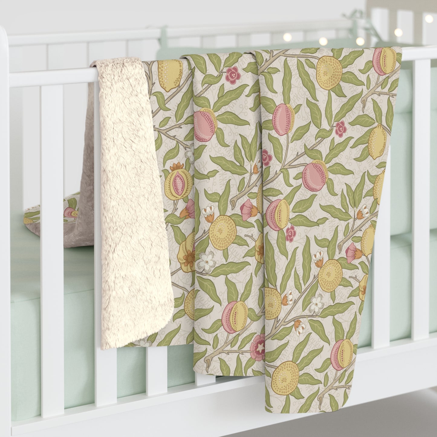Floral-patterned baby blankets hanging on a white crib
