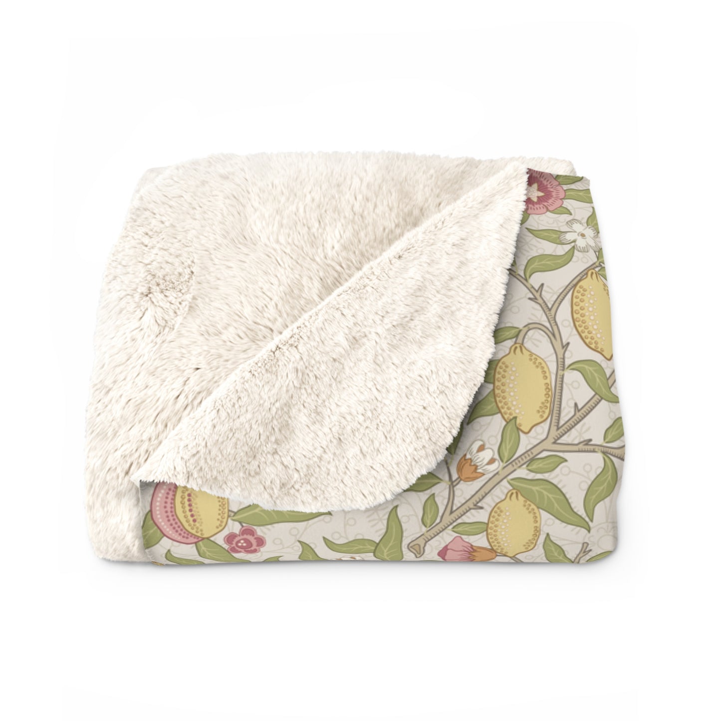 Floral-patterned blanket with white sherpa lining on a white background