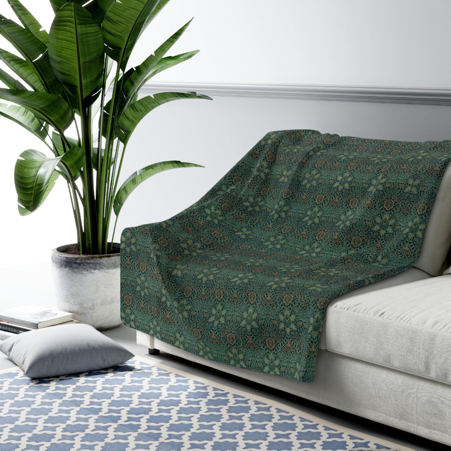 A Sherpa fleece blanket with a floral pattern in green and brown tones, underside showing plush cream sherpa fleece.