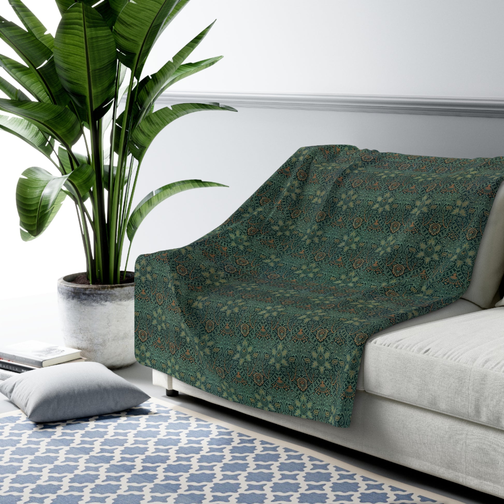 A Sherpa fleece blanket with a floral pattern in green and brown tones, underside showing plush cream sherpa fleece.