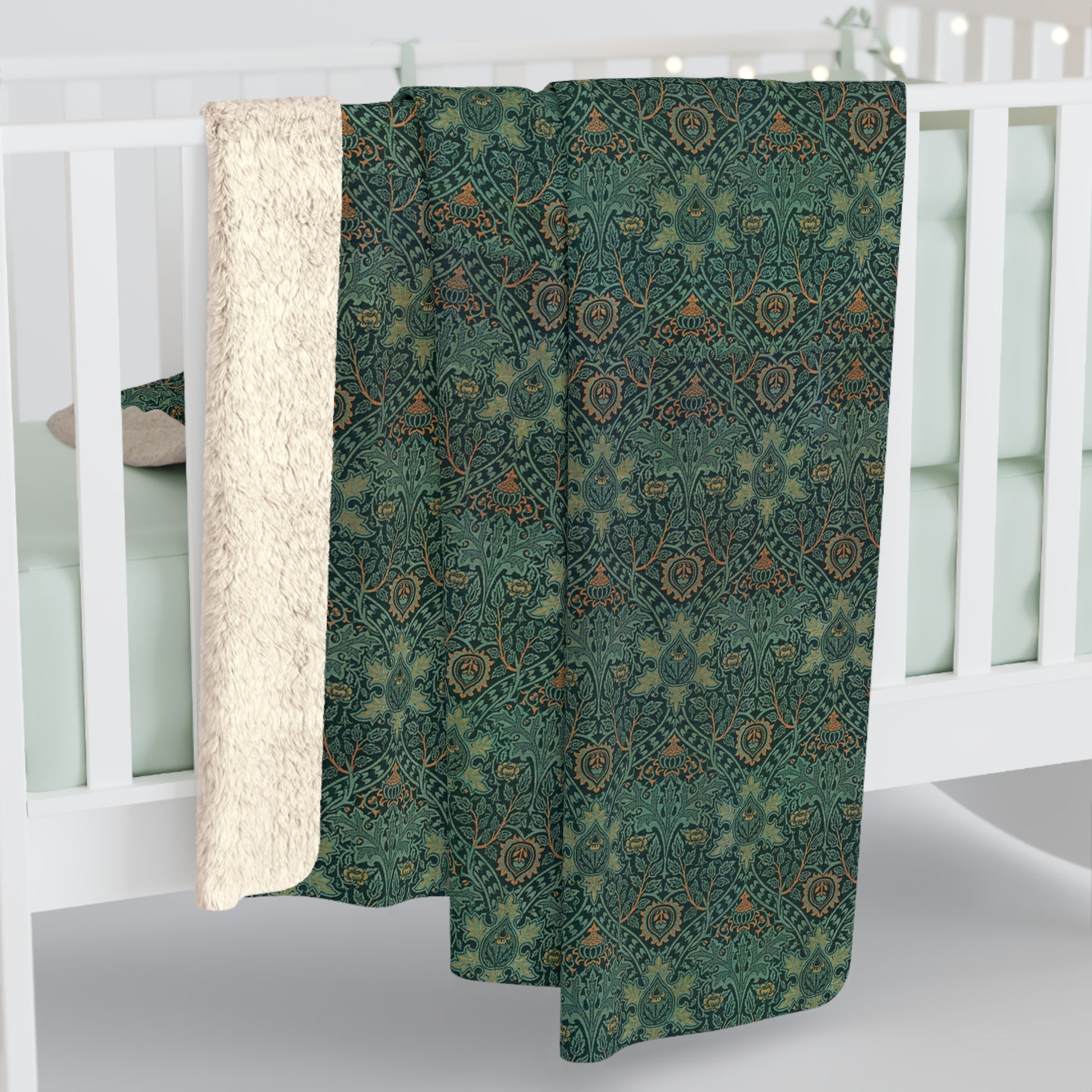 A Sherpa fleece blanket with a floral pattern in green and brown tones, underside showing plush cream sherpa fleece.