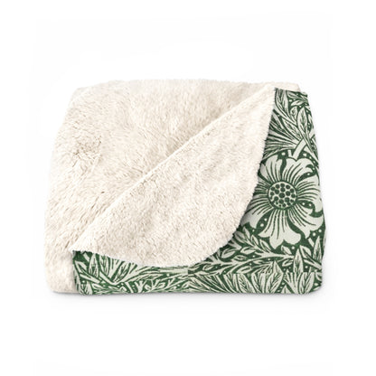 A green Sherpa fleece blanket with a floral pattern inspired by William Morris, displayed flat.